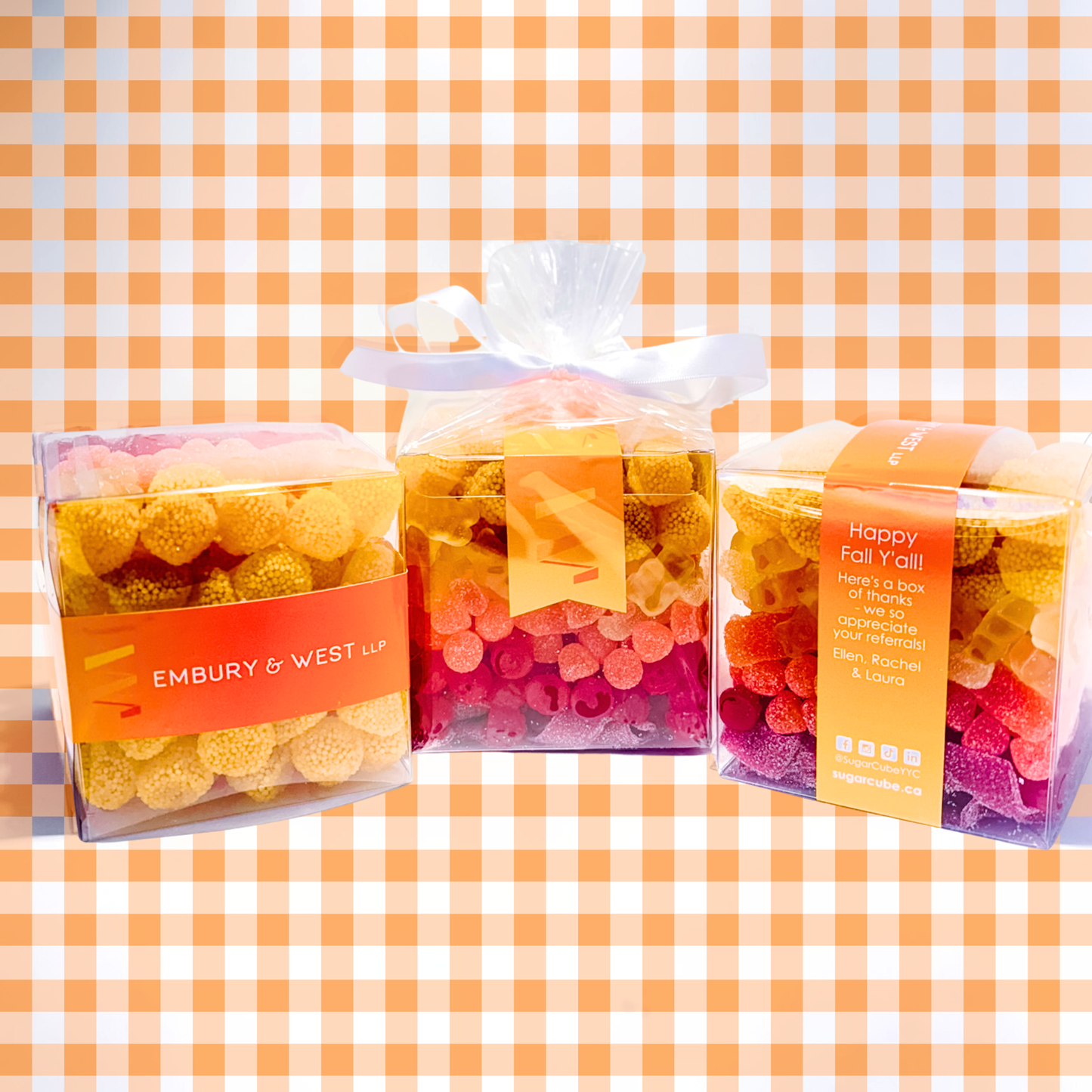 Clear Corporate CandyGram cubes featuring a yellow, orange, and red ombre candy mix that matches the branded Embry & West LLP stickers.