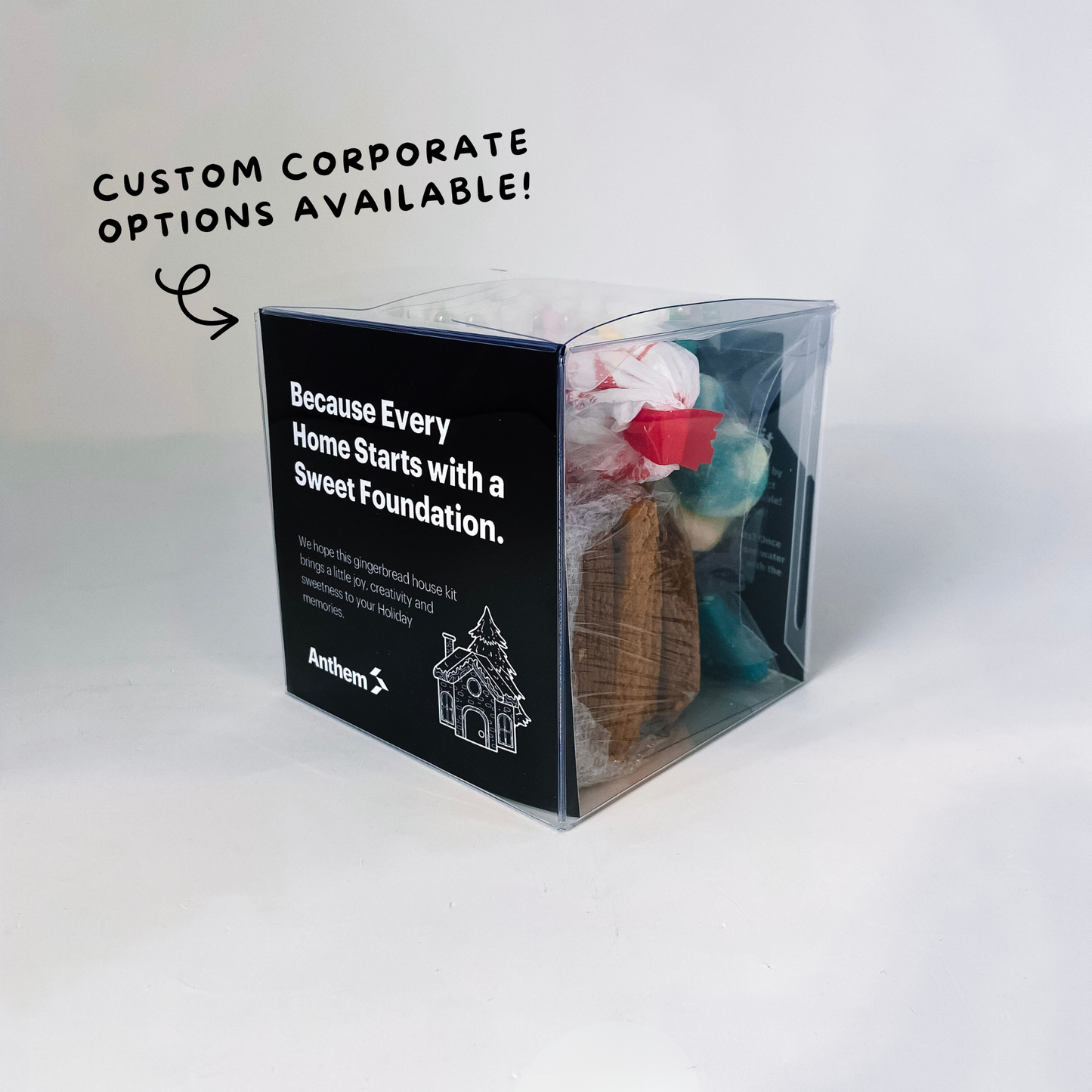 Back of custom Anthem corporate gingerbread house kit showing branded packaging and included holiday decorating supplies