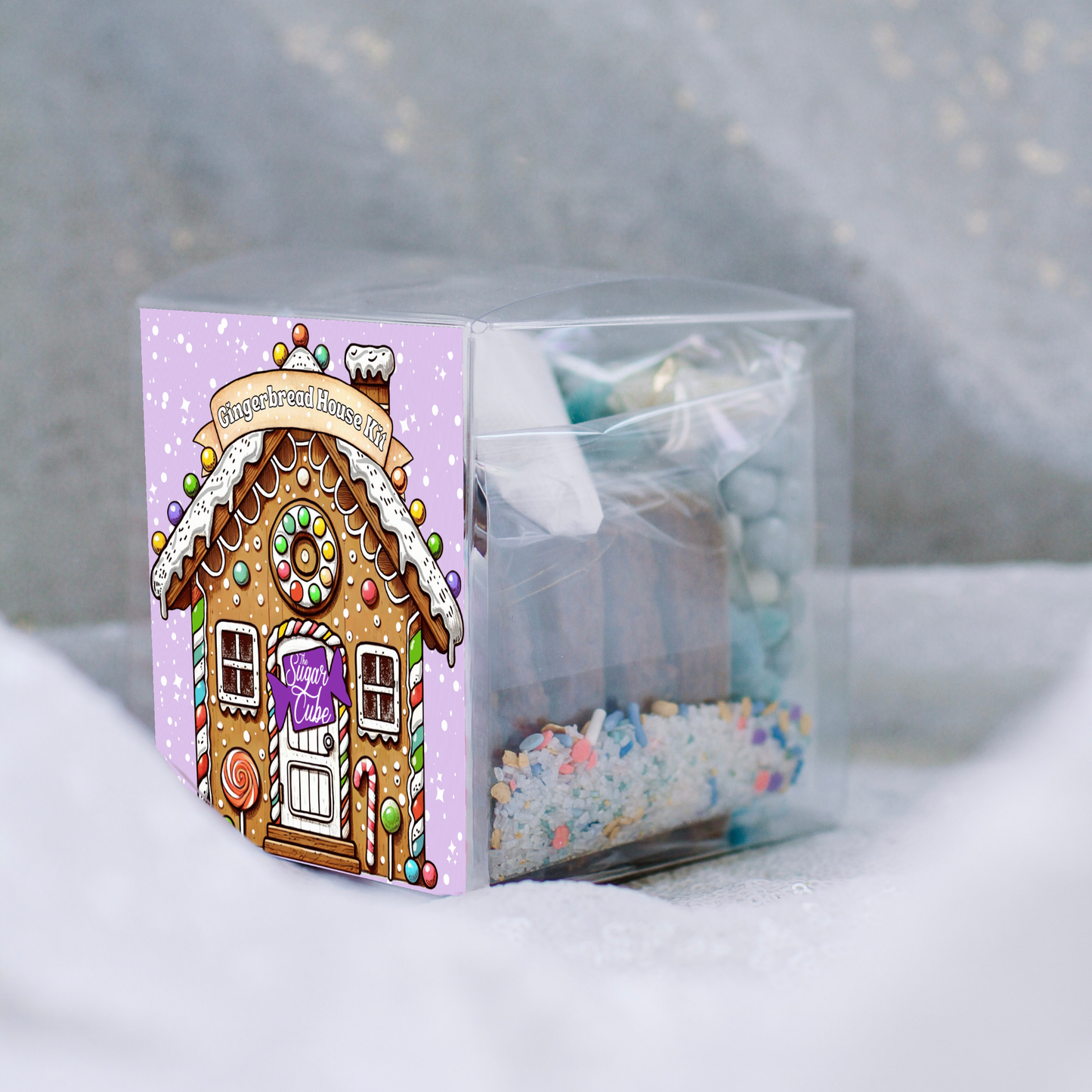 Christmas gingerbread house kit showing gingerbread pieces, frosting, sprinkles and candy included for holiday decorating