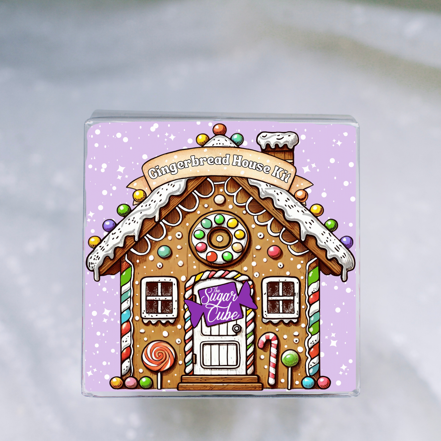 Christmas gingerbread house decorating kit shown from the front with festive holiday design insert