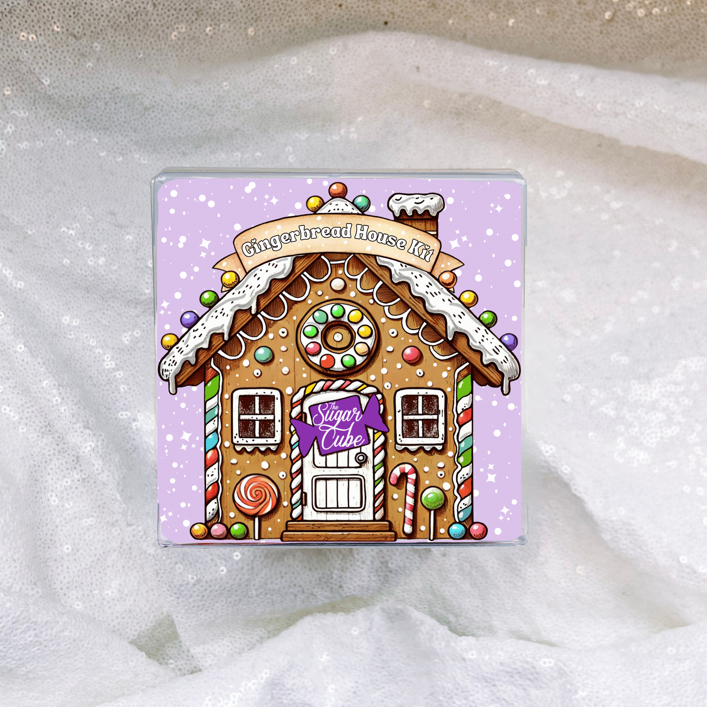 Gingerbread house kit in clear gift-ready packaging featuring the colourful Christmas design insert