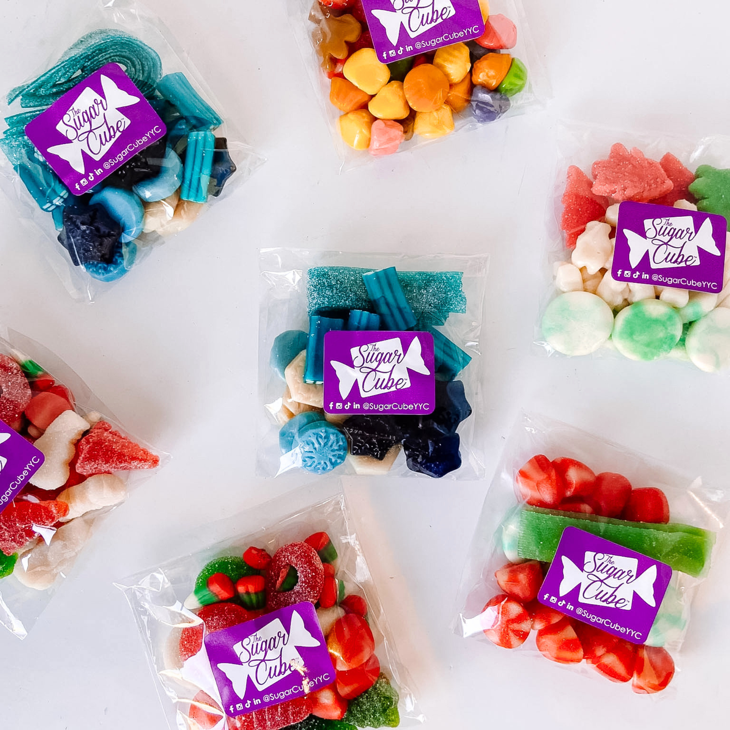 Assorted festive Christmas candy bags arranged together with colourful seasonal bulk candy mixes