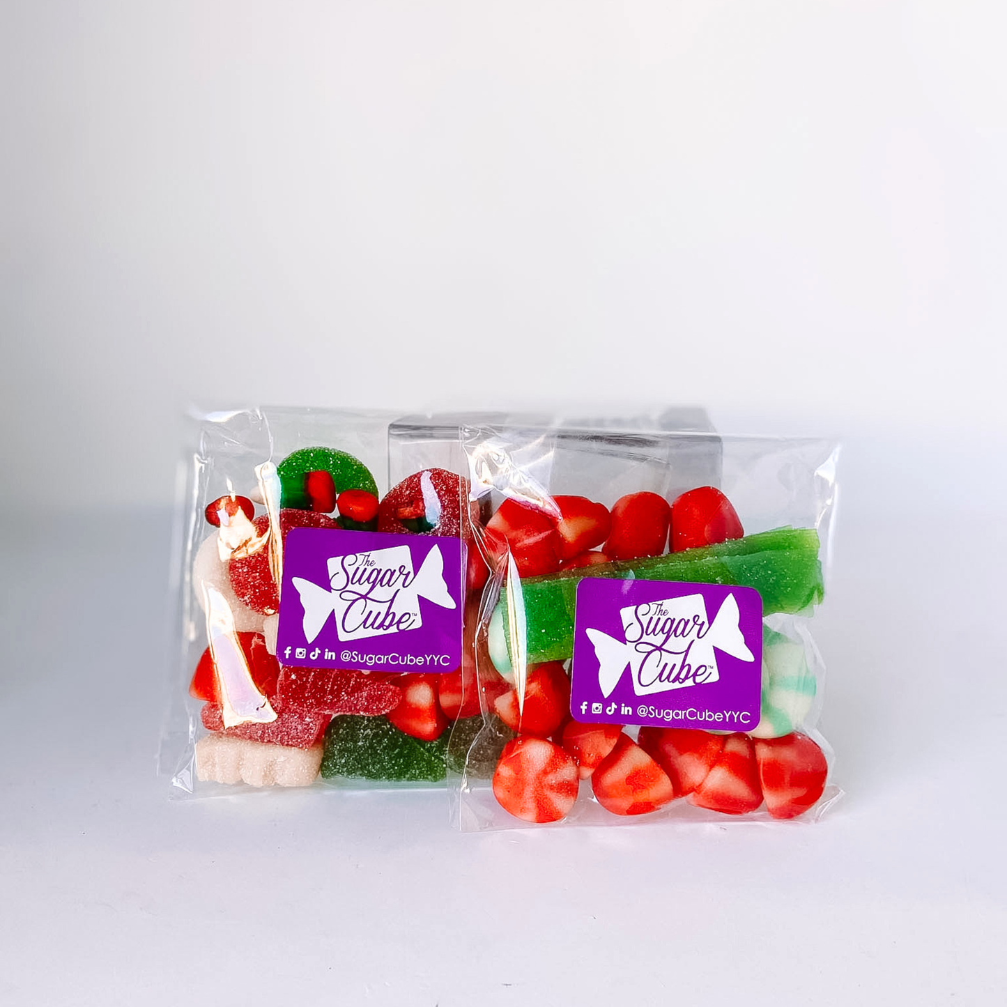 Two Home for the Holidays candy bags featuring a traditional red, green and white Christmas candy mix