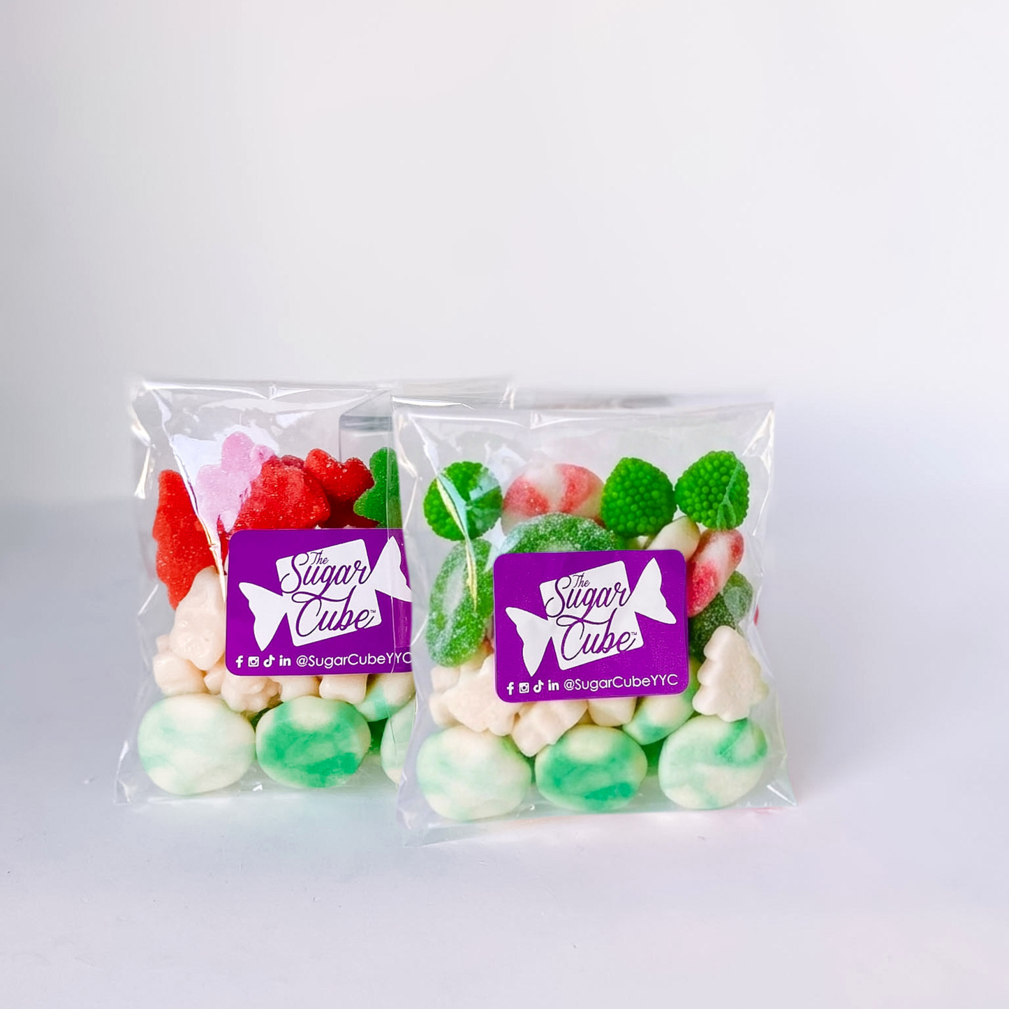 Two Merry and Bright Christmas candy bags featuring a playful mix of bright pink and green candy