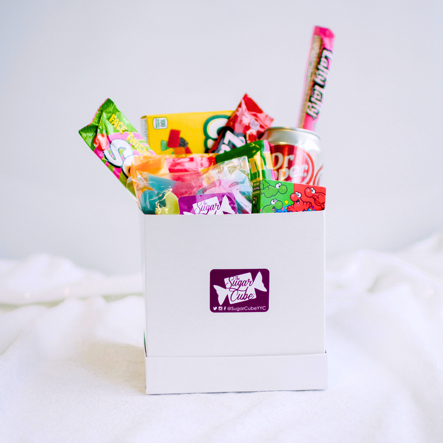 Small candy gift basket with approximately 6 to 10 assorted treats and a specialty soda can