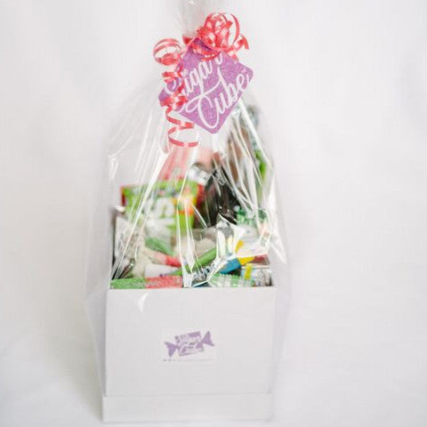 Christmas candy gift basket viewed from the front, packed with colourful holiday sweets, treats and specialty soda